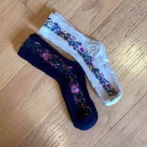 Set of 2 pair of intricately knit and brightly embroidered socks 1 black 1 ivory